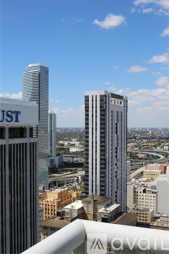 A cityscape with tall buildings and a clear sky.