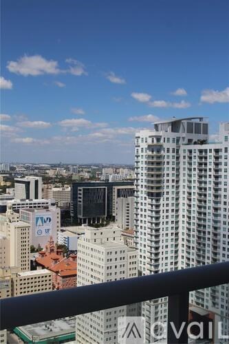 A cityscape with tall buildings and a clear sky.