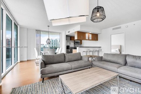 A modern living room with a grey sofa and a wooden coffee table.