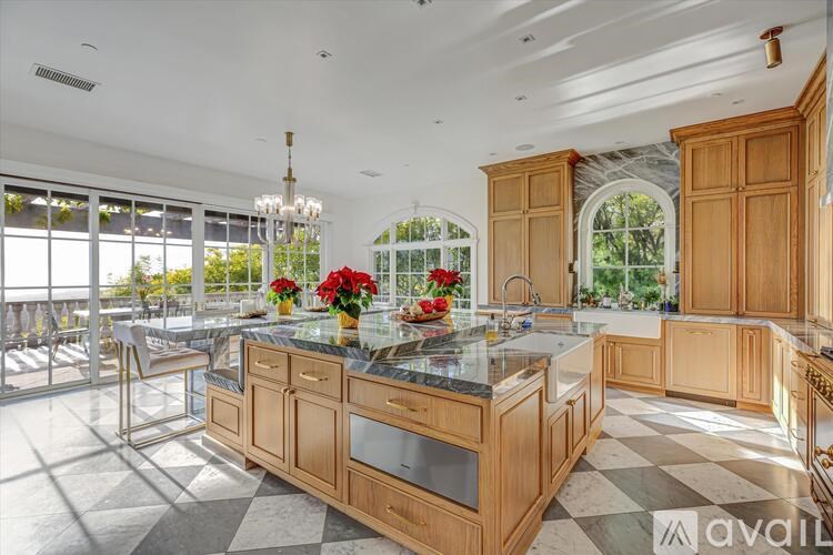 A kitchen with wooden cabinets and a marble countertop.