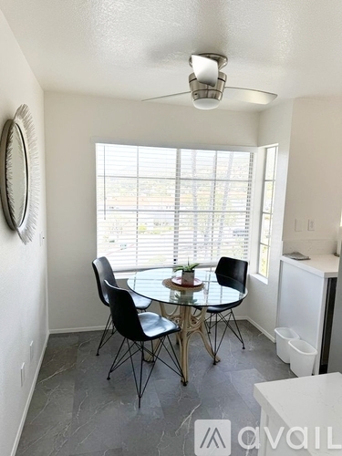 A dining room with a round table and chairs.