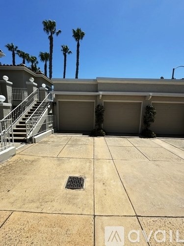 A house with a driveway and garage doors.