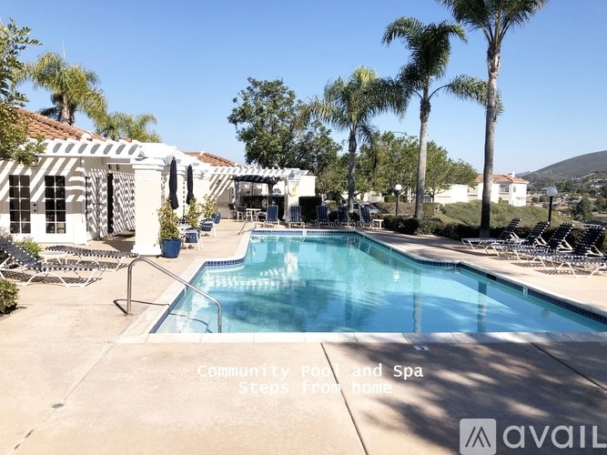 A pool and spa area with steps from home.