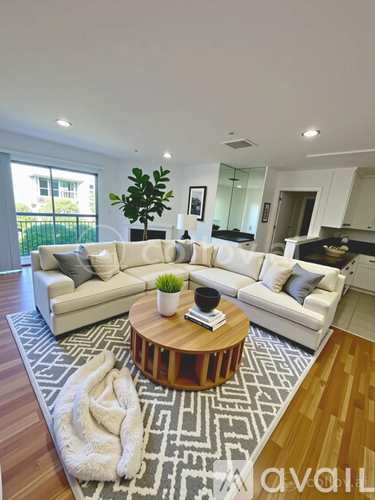 A living room with a white couch and a coffee table.