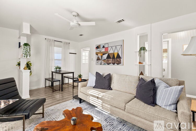 A living room with a couch, chair, and a rug.