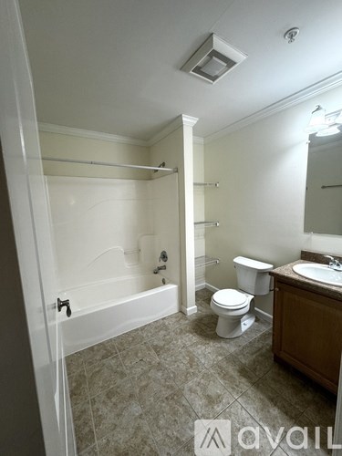 A bathroom with a toilet, sink, and bathtub.