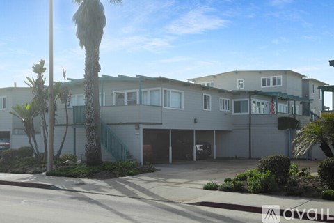 A building with a palm tree in front of it.