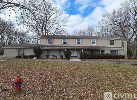 A house with a red fire hydrant in front of it.