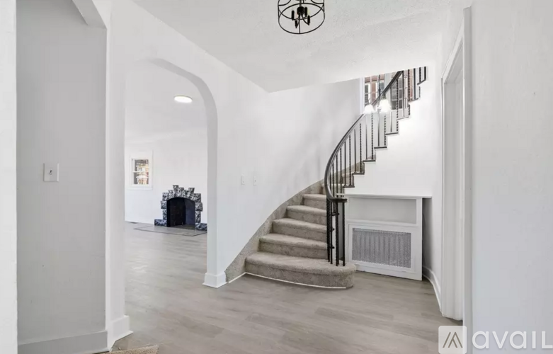 A staircase with a metal railing leads up to a second floor.