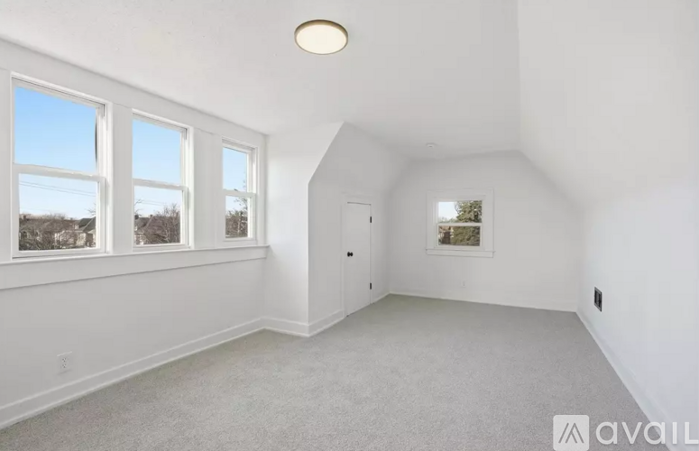 A spacious room with a window and a door.