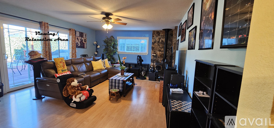 A living room with a couch, chair, and a television.