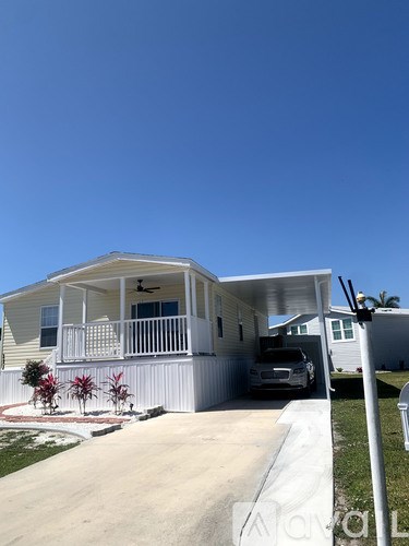A house with a car parked in the driveway.