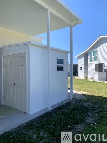 A white house with a porch and a white door.