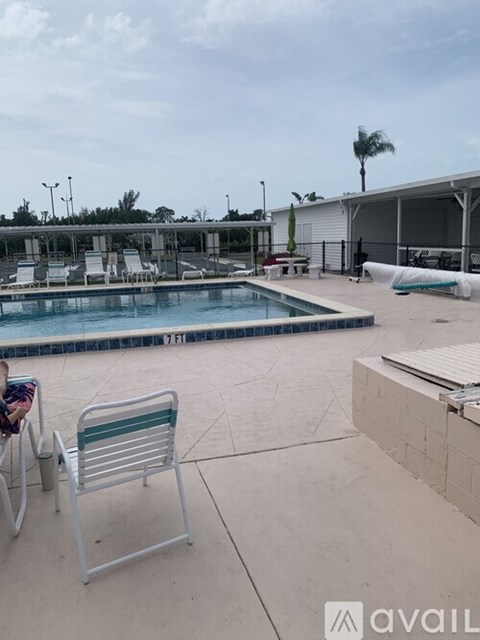 A pool area with a chair and a pool table.