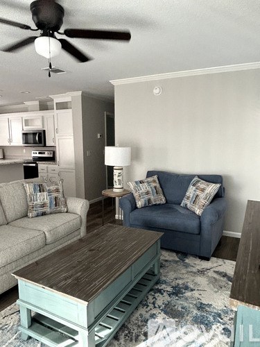A living room with a blue couch and a wooden coffee table.