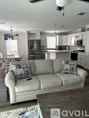 A living room with a couch and a dining table.