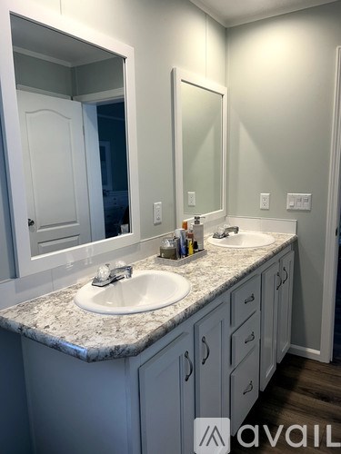 A bathroom with a sink and mirror.