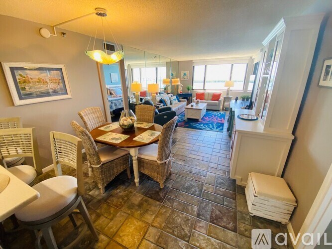 A living room with a dining table and chairs.