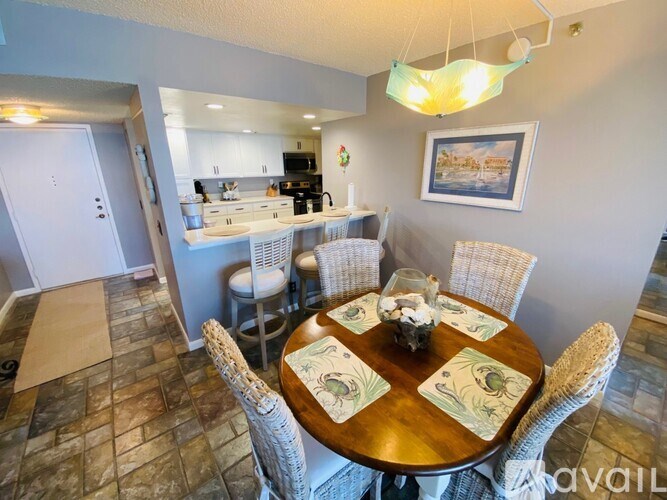 A dining room with a round table set for four.