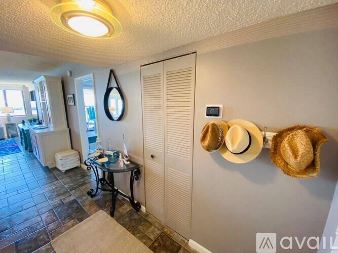 A hallway with a hat rack and a mirror on the wall.