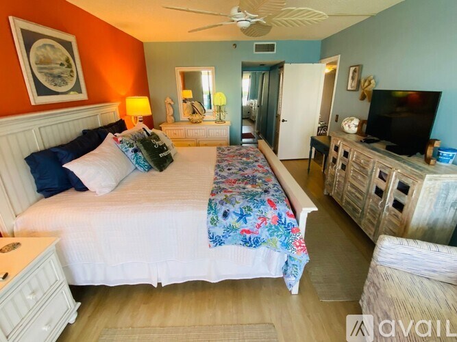 A bedroom with a large bed and a television.