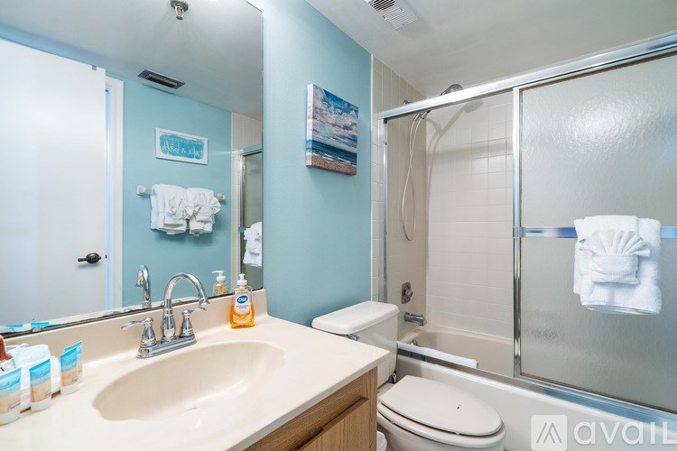 Two twin beds with blue and white bedspreads in a room with blue walls.
