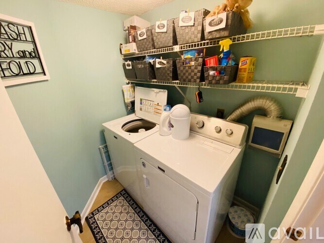 A small laundry room with a washer and dryer.