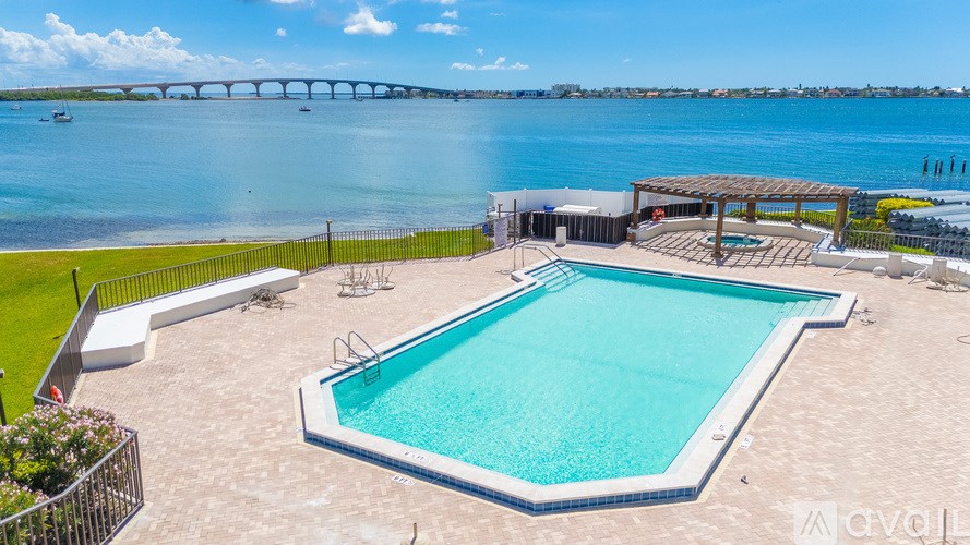 A large outdoor swimming pool with a bridge in the background.