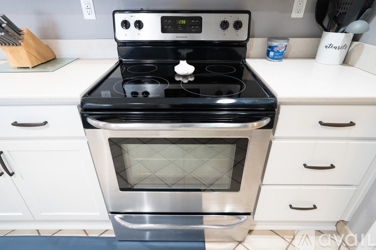 A black and silver stove top oven with a digital display in the middle.