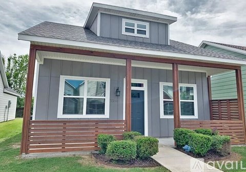 A house with a grey roof and a blue door.