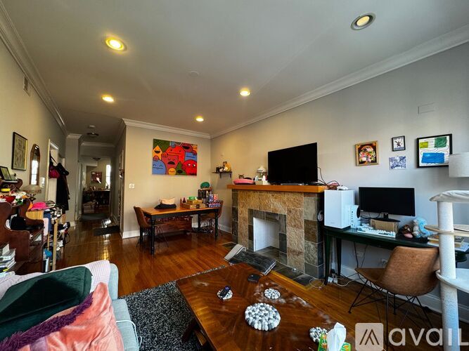 A living room with a fireplace and a television.