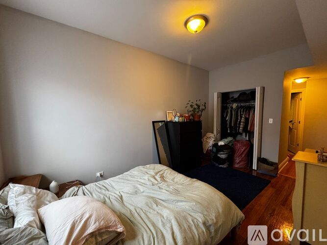 A bedroom with a bed, a dresser, and a mirror.