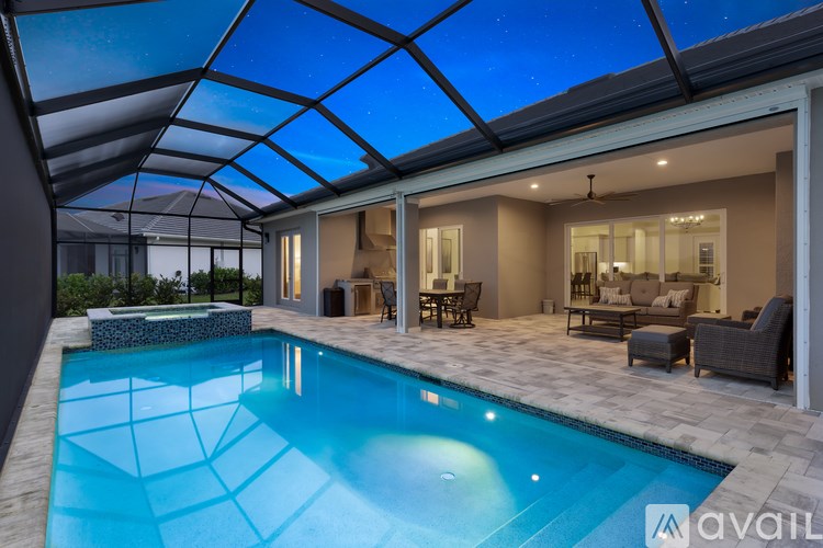 A modern house with a swimming pool under a glass ceiling.