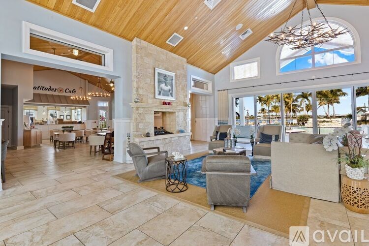 A large open space with a stone fireplace and a pool table.