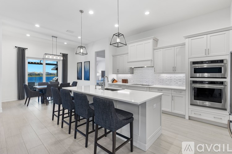 A modern kitchen with a large island and bar stools.