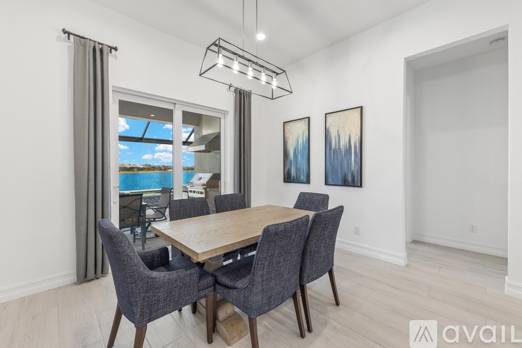 A dining room with a wooden table and grey chairs.
