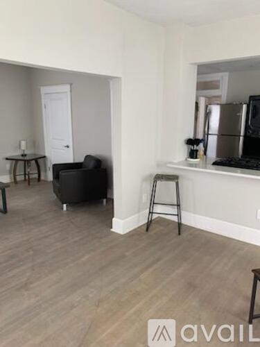 A living room with a black chair and a small table.