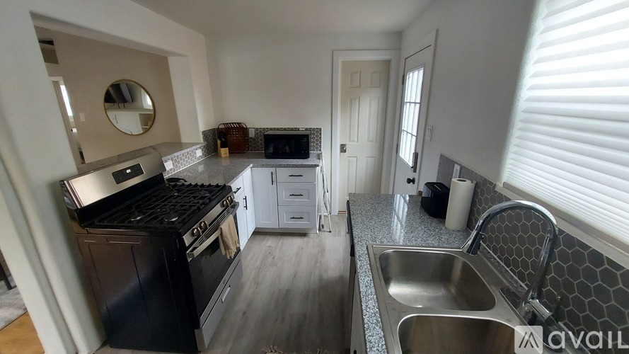 A kitchen with a black stove top oven and a white fridge freezer.