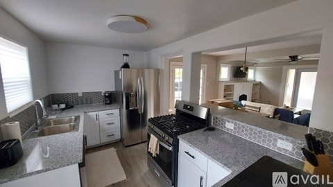 A kitchen with a black stove top oven and a black fridge.