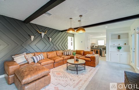 A living room with a large sectional sofa and a coffee table.