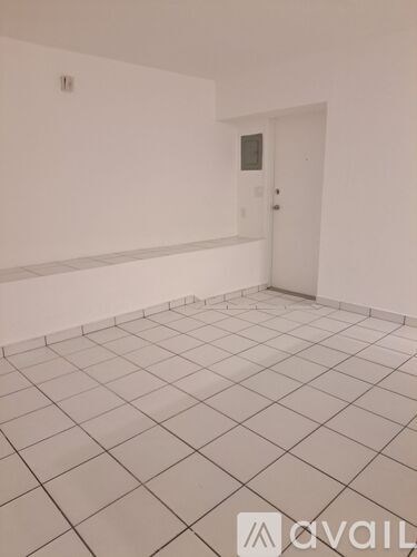 A room with white walls and a tiled floor.