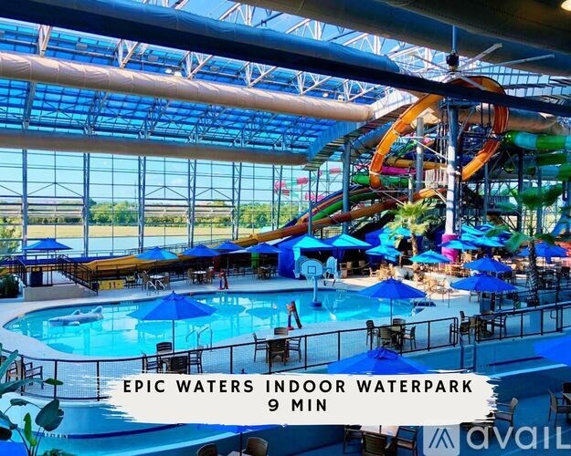 A waterpark with a slide and a pool.