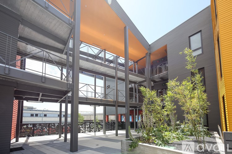 A modern building with a glass wall and a yellow awning.