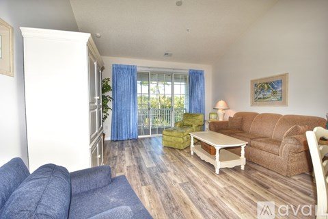A living room with a blue couch and a brown couch.