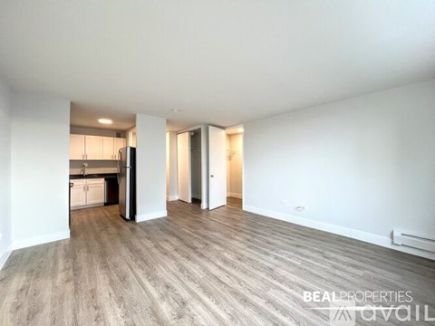 A white bathroom with a walk in shower and a white towel rack.