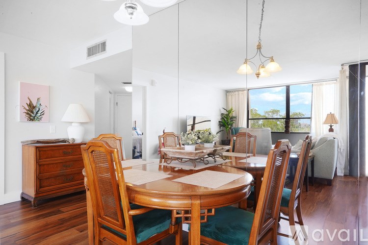 A dining room with a wooden table and chairs.