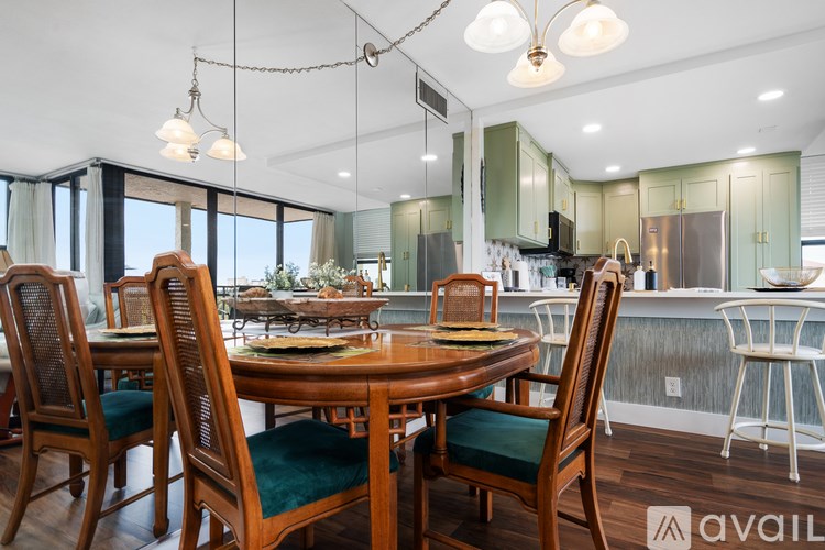 A dining room with a wooden table and chairs.