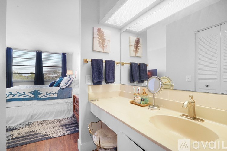 A bathroom with a bed and a sink.