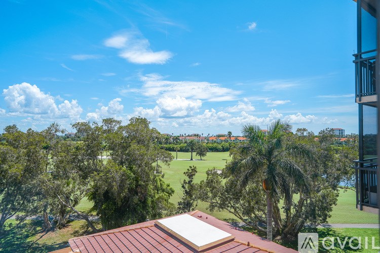 A view from a balcony overlooking a lush green landscape.