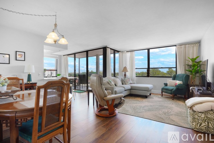 A living room with a dining table and chairs.